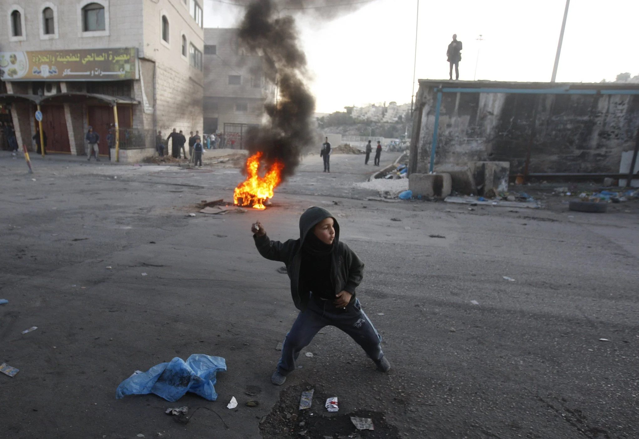 A Palestinian child throws a stone at Israeli occupation forces, 2011. Photo via Reddit
