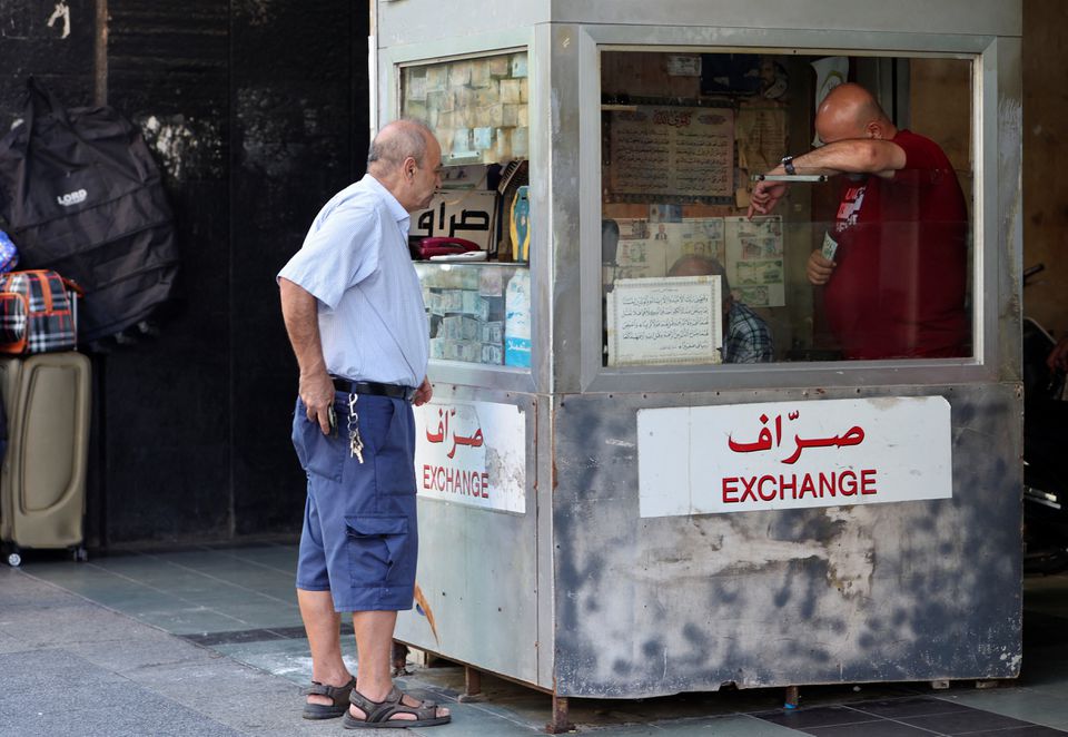A man stands outside a currency exchange booth in Beirut, Lebanon Sept. 29. Photo: Aziz Taher/Reuters