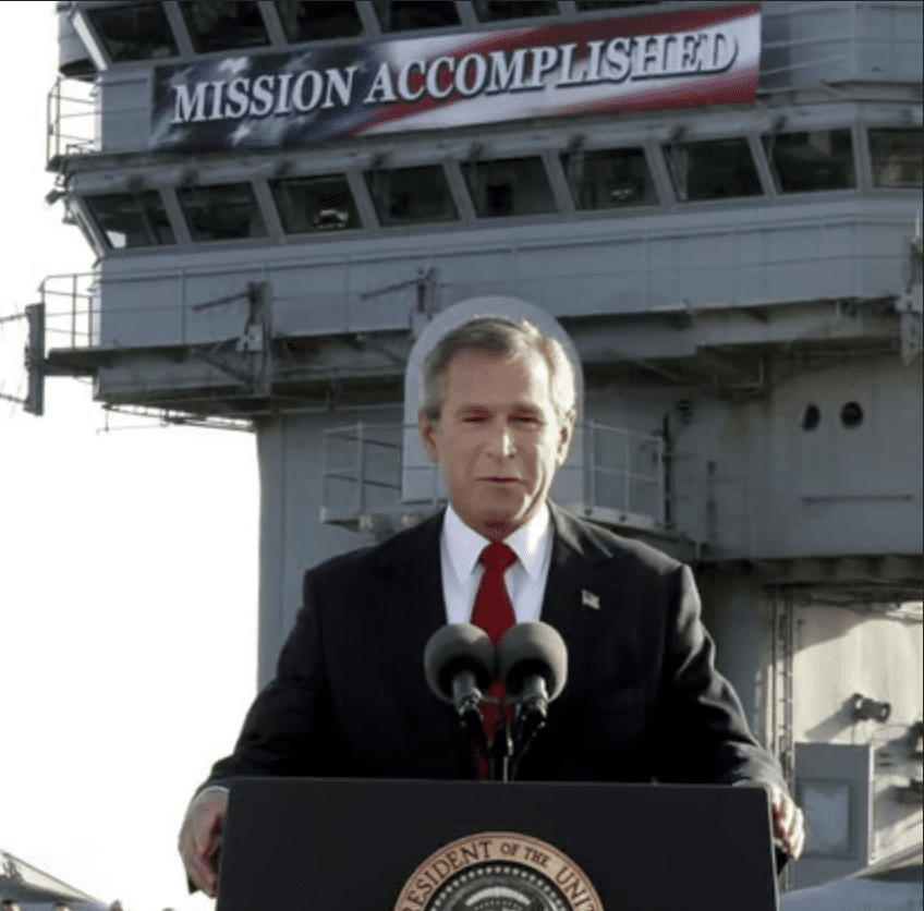 Former President George W. Bush declares the major fighting over in Iraq as he speaks aboard the USS Abraham Lincoln off the California coast in May 2003. - File photo