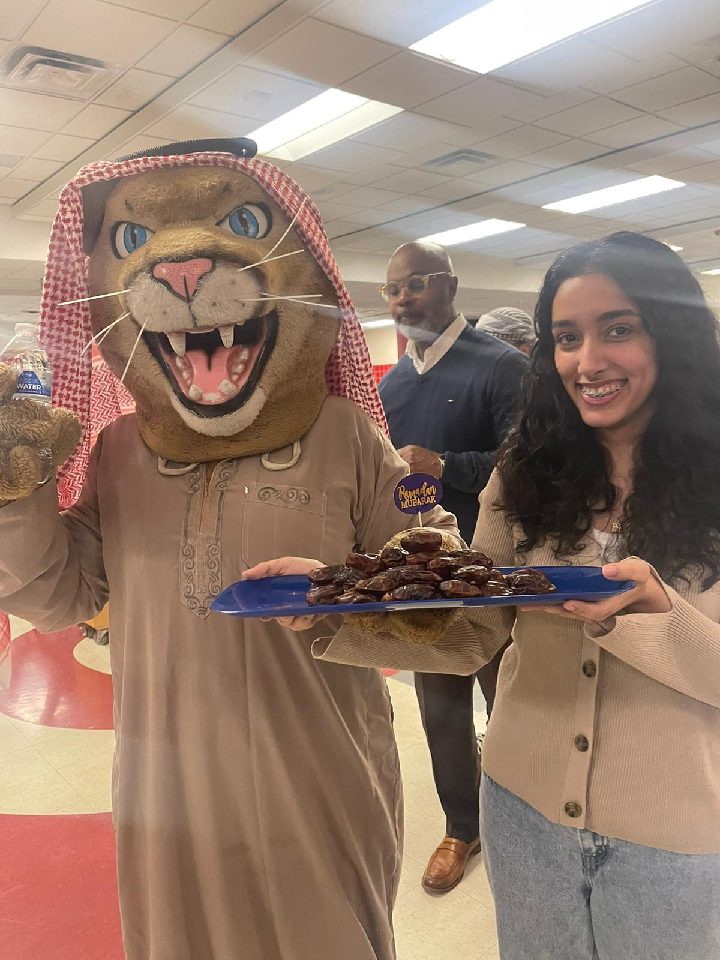 Annapolis High School mascot, Freddy Cougar, and ASU founder and Annapolis senior, Tomasia Suleiman at the first Iftar dinner. Photo courtesy of Tomasia Suleiman