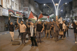 Palestinians march with Palestinian flags as they protest against Israel's ongoing airstrikes and raids on the second day in Jenin, in Hebron, West Bank on July 04, 2023 [Mamoun Wazwaz/Anadolu Agency]