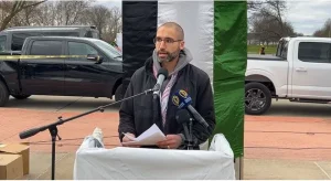 Dr. Adam Fahd, an Ascension orthopedic trauma surgeon, speaks at the International Day of Al-Quds on Friday, April 5 outside of the Henry Ford Centinnial Library on Michigan Ave, in Dearborn. Videograb.