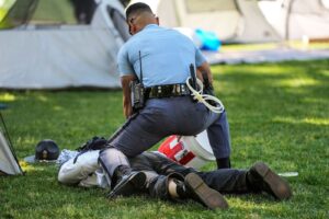 A Georgia State Patrol officer detains a protester on the campus of Emory University during a pro-Palestinian demonstration Thursday, April 25, in Atlanta. – Photo by AP
