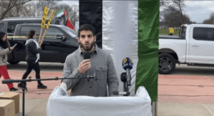 Tarek Bazzi, a Dearborn activist, speaks at Friday’s Al-Quds rally in Dearborn. – Videograb
