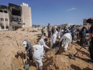 The Palestinian Civil Defense recovering bodies on Sunday from what it is calling a mass grave at Nasser Hospital in Khan Younis