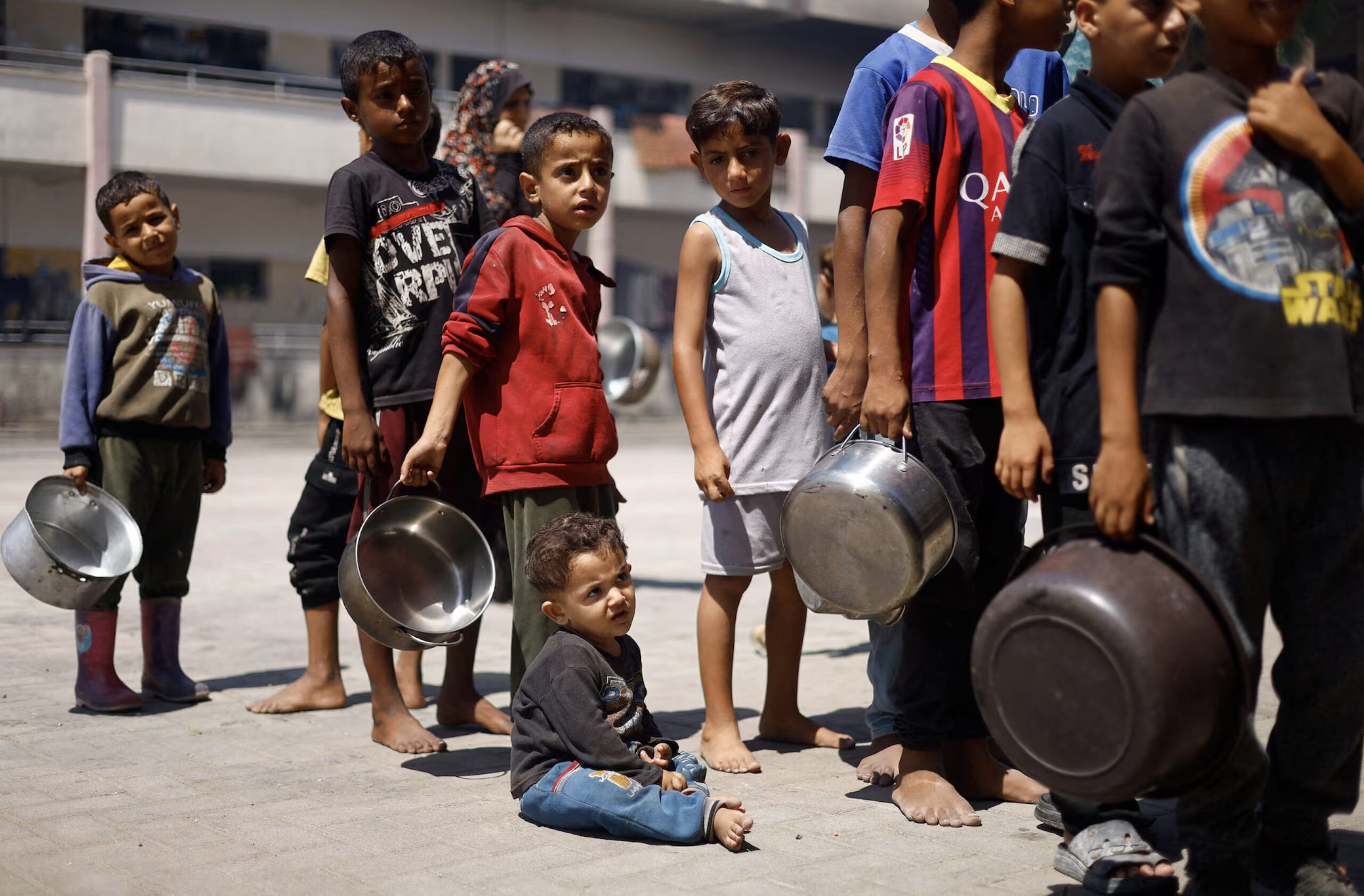 Palestinian children gather to receive food cooked by a charity kitchen, amid food scarcity, as Israel-Hamas conflict continues, in Khan Younis in the southern Gaza Strip, June 26, 2024. – Photo by Reuters