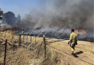 Israeli firefighters work following rocket attacks from Lebanon, amid ongoing cross-border hostilities between Hezbollah and Israeli forces, near the border on its Israeli side, June 13, 2024. REUTERS