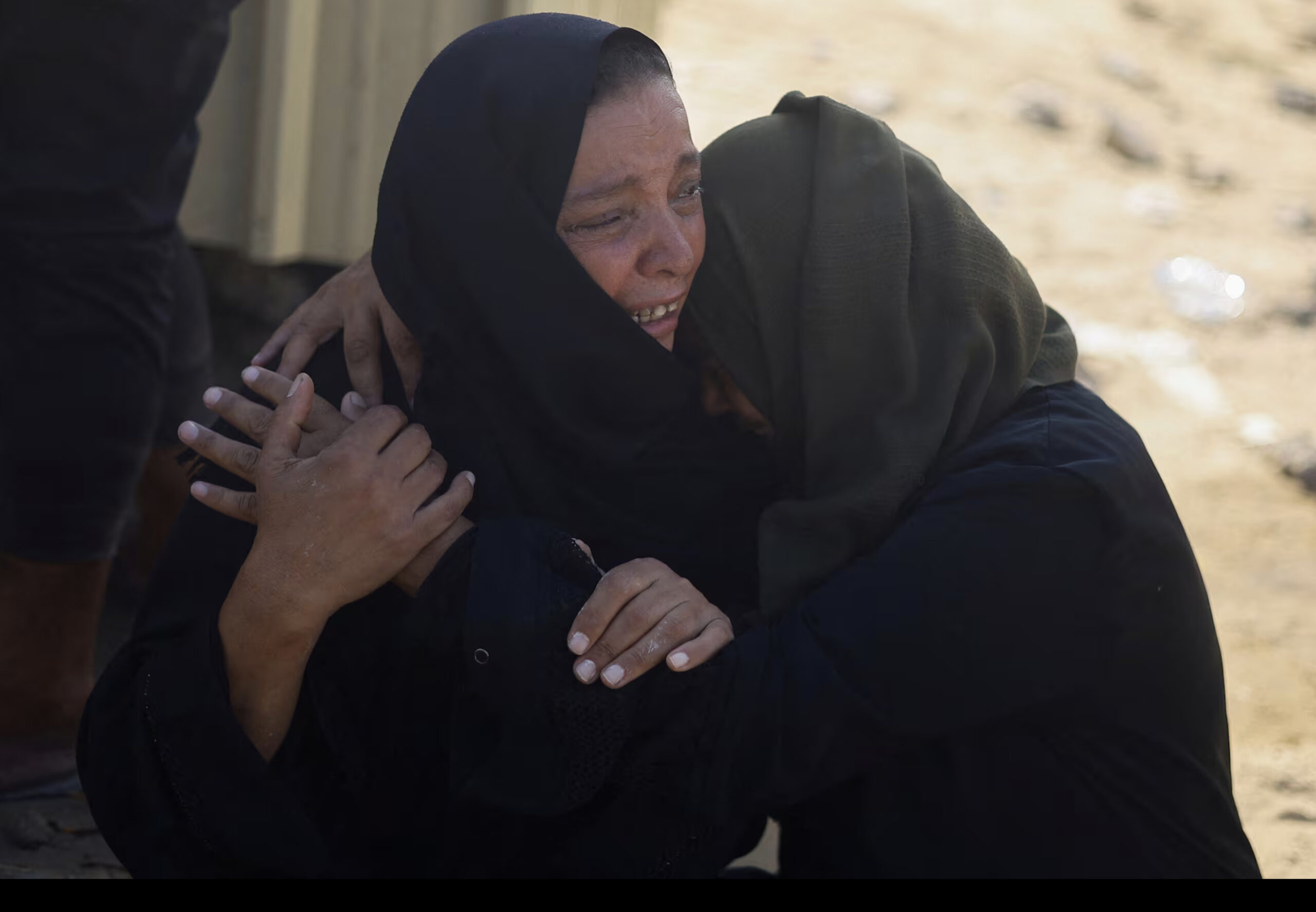 Mourners embrace during the funeral of Palestinians killed in the Israeli strikes, amid Israeli war on Gaza, at Nasser hospital, in Khan Younis, southern Gaza Strip July 24. Reuters