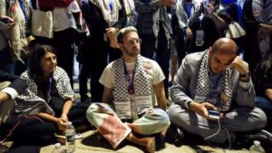 A group of 'uncommitted' delegates hold a sit-in outside the Democratic National Convention to protest against the lack of a Palestinian American speaker. – EPA