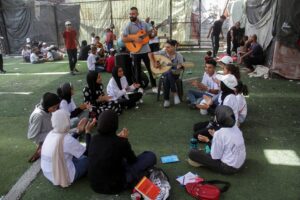 Palestinian teenager Youssef Saad plays oud to bring joy to people, amid Israel-Hamas conflict, in Jabalia refugee camp in the northern Gaza Strip September 2. – Photo by Reuters