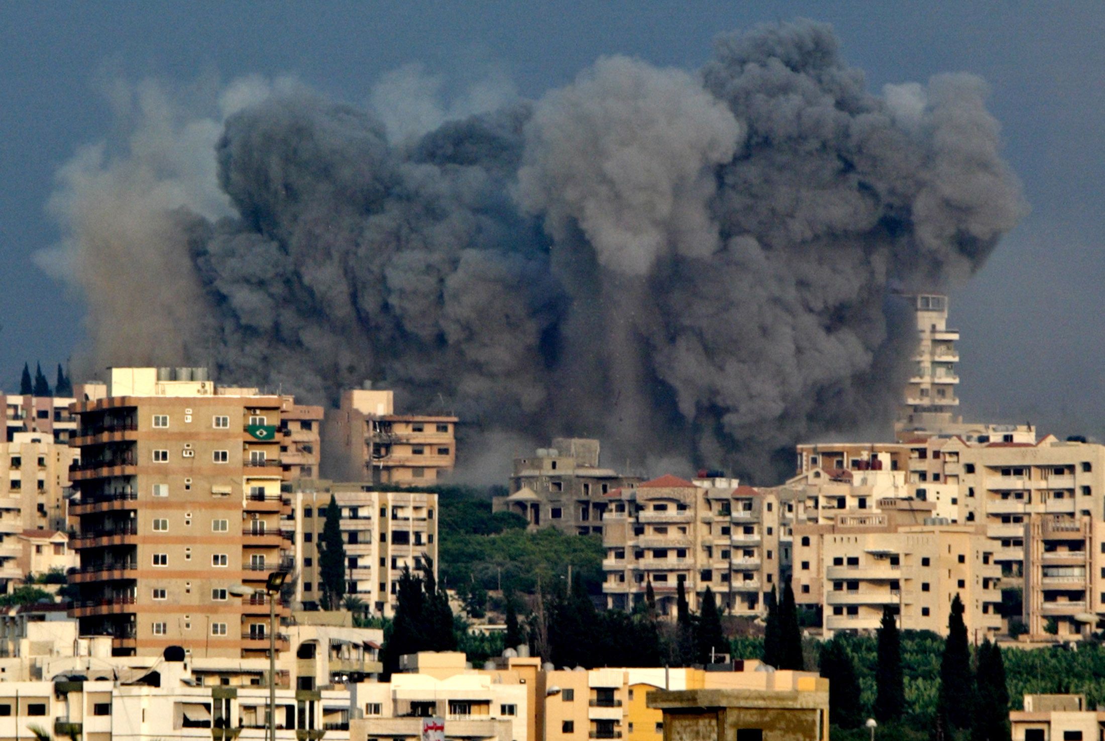 Smoke rises as a building collapses in Beirut's southern suburbs following Israeli attack