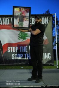 Hassan Harb holds a picture of his older brother Rabih Harb, who was killed in an Israeli attack at his house in the southern Lebanese city of Bint Jbeil.