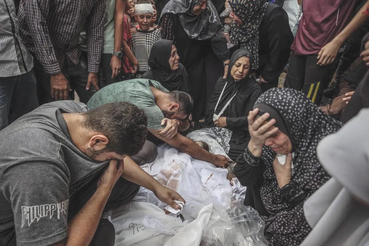 Relatives of the dead who lost their lives in the Israeli army's attack on a house at the Bureij refugee camp mourn during the funeral ceremony after the bodies of the dead were taken from the morgue of Al-Aqsa Martyrs Hospital in Deir al-Balah, Gaza on October 8. – Photo by the Anadolu Agency