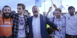 Israel's far-right National Security Minister Itamar Ben-Gvir (C) dances during a conference calling for Jewish resettlement of the Gaza Strip, near the Israeli-Gaza border, southern Israel, 21 October 2024.