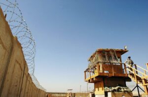 A U.S. soldier stands guard at Abu Ghraib prison west of Baghdad June 19, 2006. More than 300 detainees were released on June 19, 2006 from Abu Ghraib prison. 2,500 inmates are to be released under Iraqi Prime Minister Nuri al-Maliki's national reconciliation plan. REUTERS