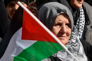 A Palestinian woman carries a Palestinian flag during a protest in solidarity with the Palestinian people and to demand the opening of Rafah border crossing between Egypt and the Gaza Strip, outside of the Egyptian embassy in Beirut, Lebanon, January 18,2024.- File photo