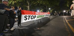 Demonstrators hold a banner in support of Palestinians in the Gaza war outside of Vice-President Kamala Harris presidential rally near Howard University in Washington