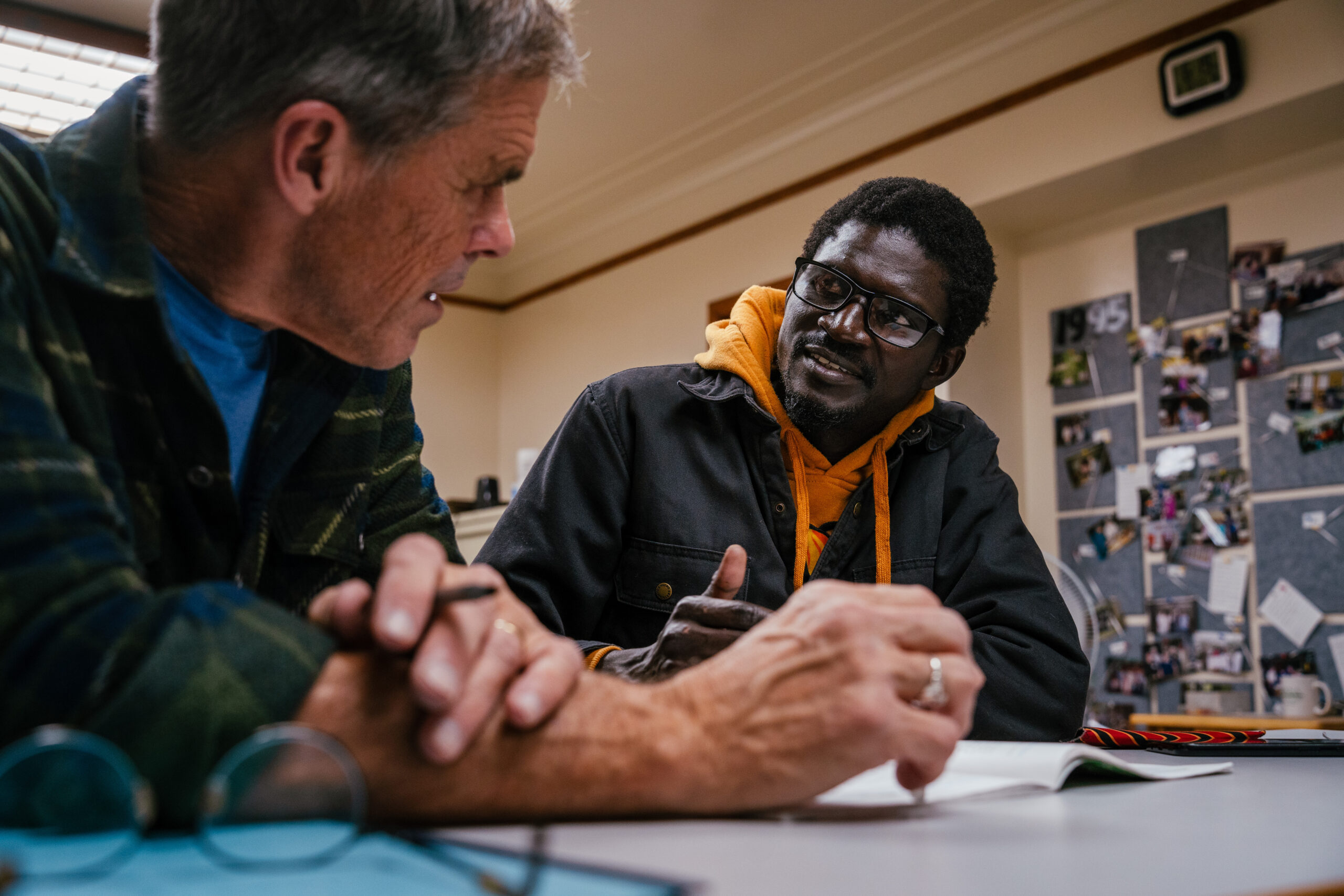 Instructor Kevin Gordon helps Serigne Lo, an ESL student from Senegal, study language needed for a driver's exam.