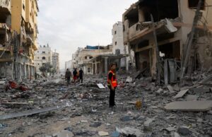 A rescuer looks on amid debris in the aftermath of Israeli strikes, in Gaza City on Oct. 11, 23. Photo by Reuters