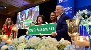 Detroit Mayor Mike Duggan and Detroit District 2 Manager Kim Tandy present Dr. Fakhouri with the street sign that carries her name and will be mounted on Seven Mile Road and Brady Street. 