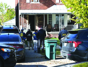 Federal agents search a house on Horger Street in East Dearborn on the eve of Halloween.