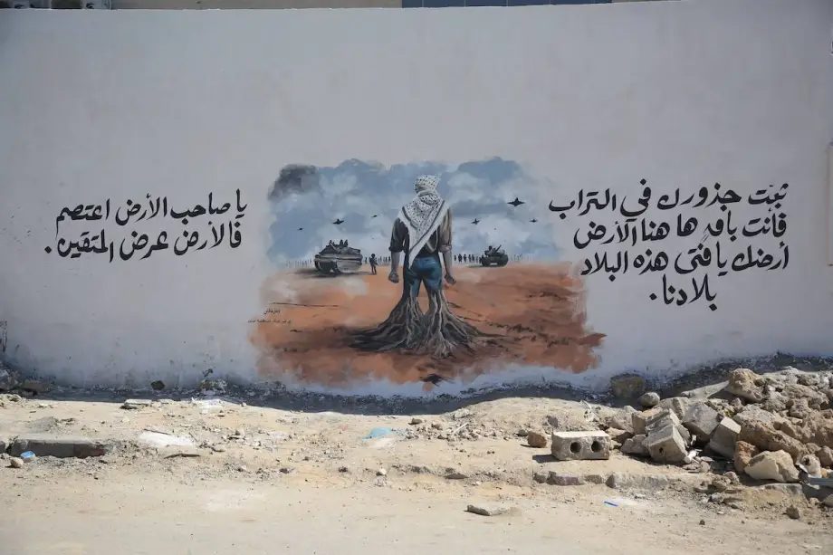 Palestinian painter Fazil Tafish, living in Gaza, create an artwork symbolizing the people’s resistance and attachment to their land on the wall of Al-Ahli Baptist Hospital as Israel’s ongoing attacks on Gaza mark their first anniversary, in Gaza city, Gaza on October 10, 2024. Photo via Anadolu