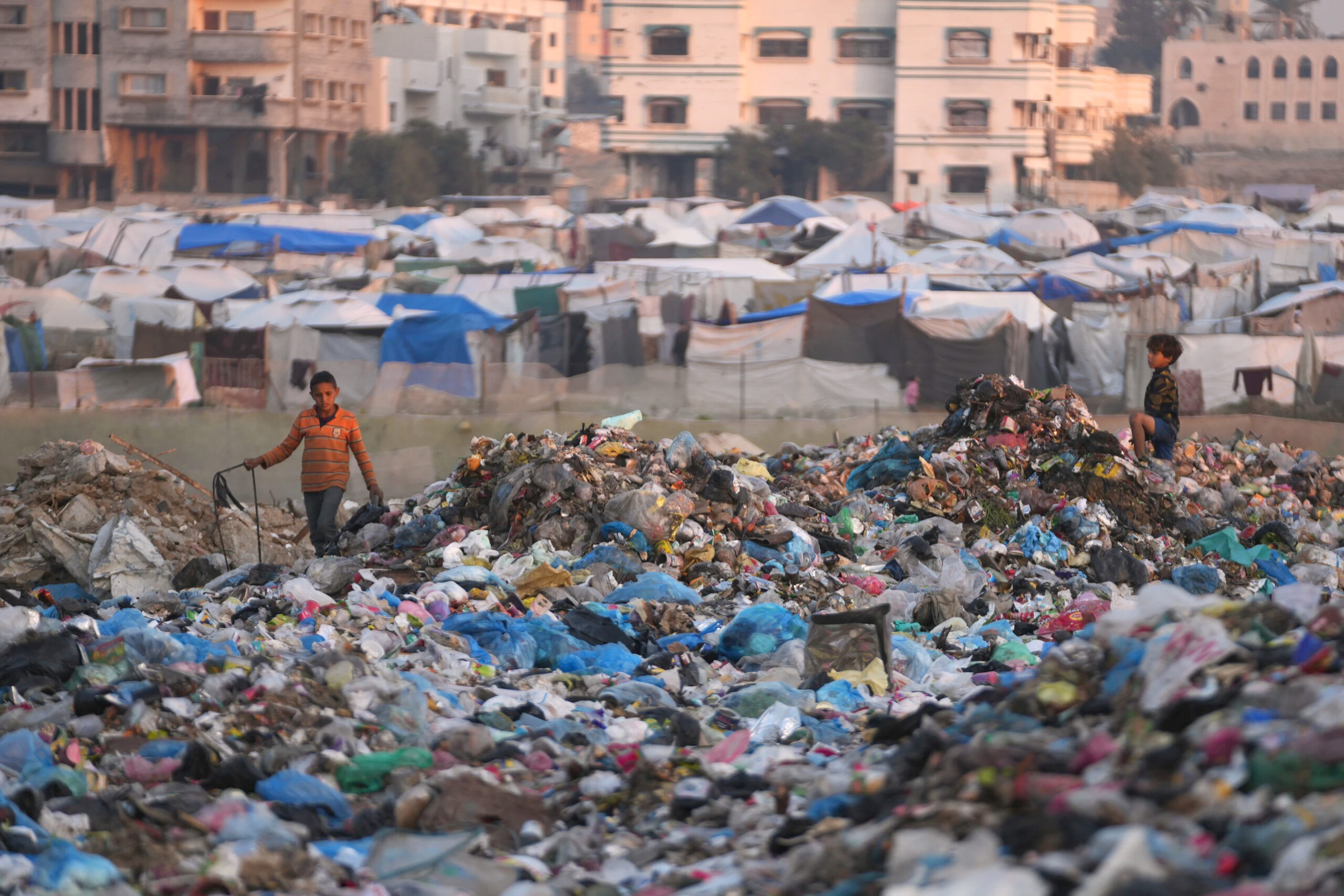 Palestinian children sort through trash at a landfill in al-Bureij camp, in the central Gaza Strip, Wednesday, December 24, 2025. – Photo by AP