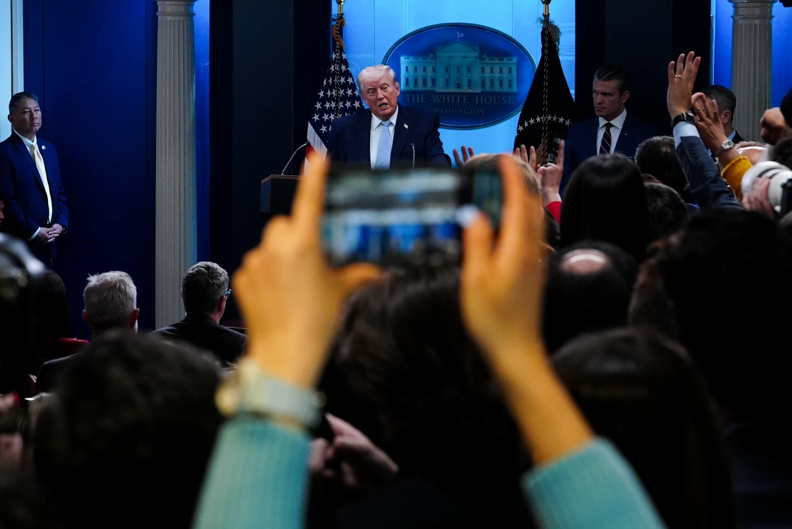 President Trump speaks to reporters at the White House, flanked by Defense Secretary Pete Hegseth and Gen. Dan Caine. (AP)